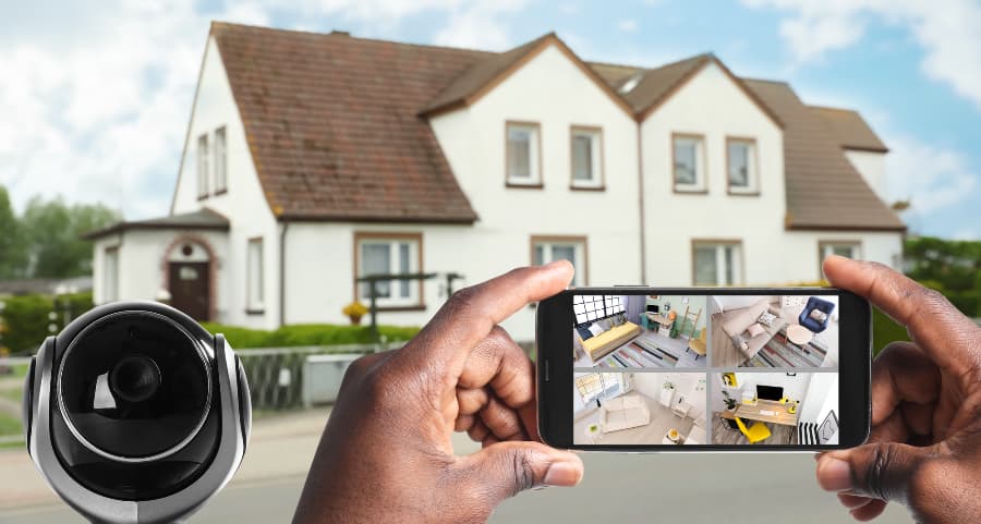 Man holding phone and viewing streams from surveillance cameras